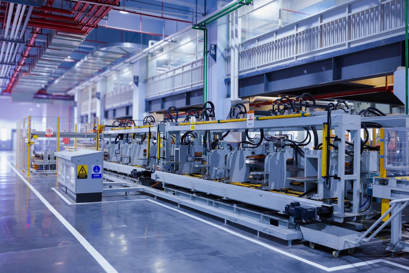 A modern industrial production floor with automated machinery