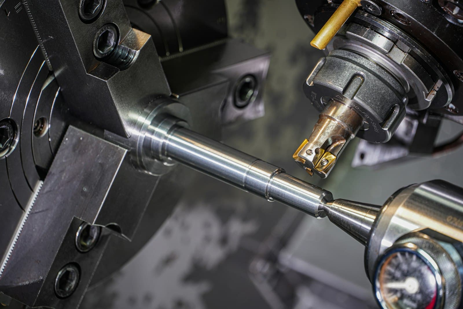 Close-up of precision lathe machining a polished metal shaft